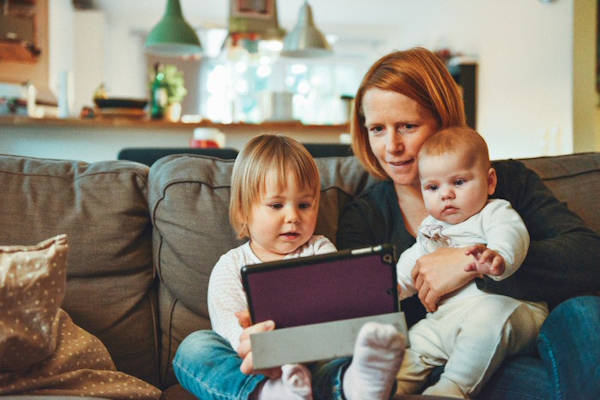 Parent spending time with children using a tablet