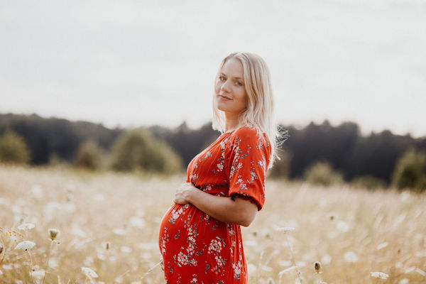 A pregnant Woman in A Red Floral Dress